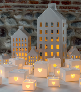 Candle and lights coming from big and small white lanterns made with paper by Scotton